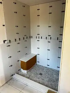 Walk-in shower installation featuring custom tile work and built-in bench, part of an accessory dwelling unit in Essex, MA.