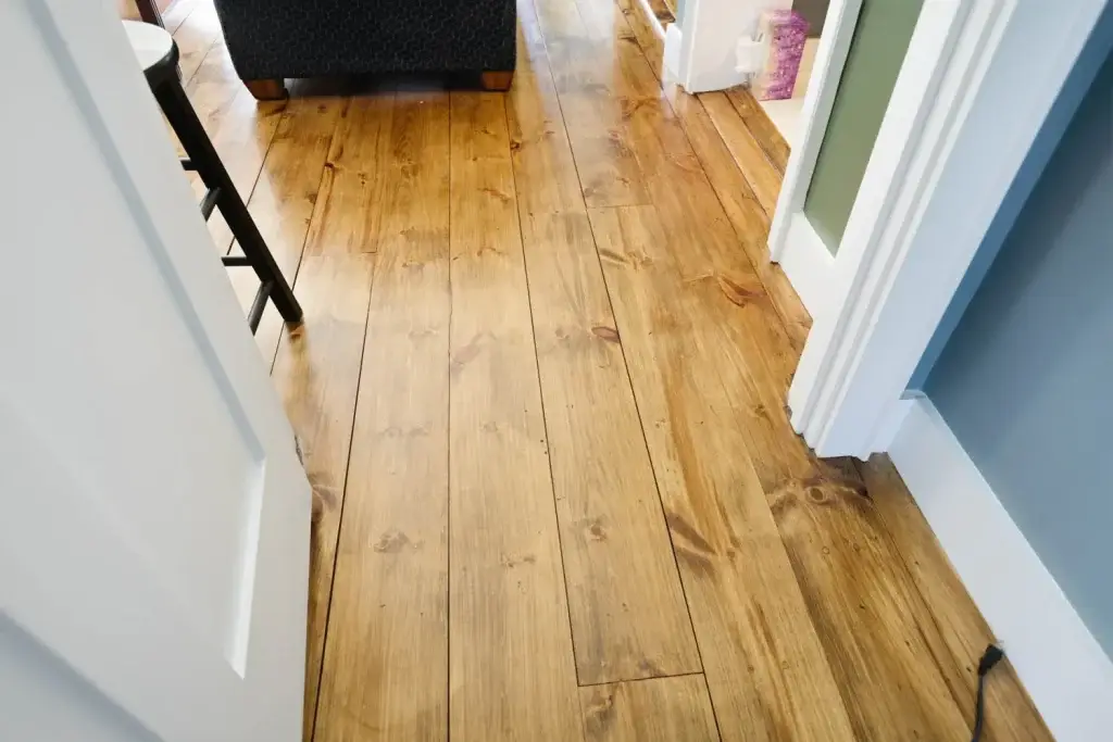 Wooden flooring in a well-lit interior space, showcasing sustainable bamboo flooring as part of healthy home design, emphasizing aesthetics and indoor air quality.