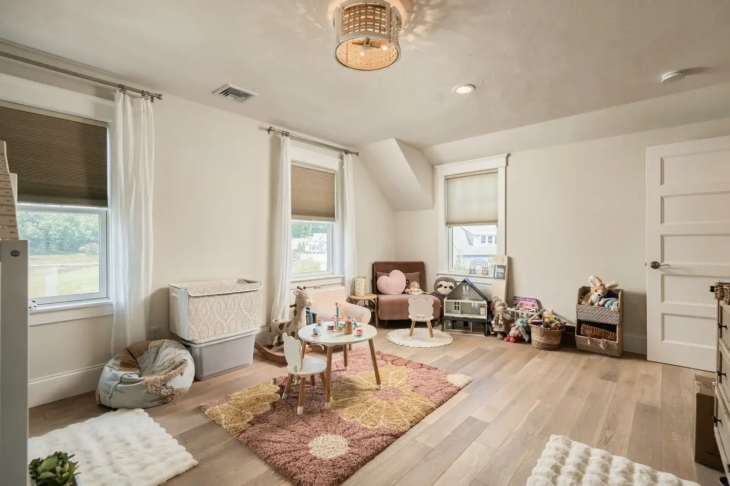 Upstairs child's bedroom with sloped ceiling and wood flooring
