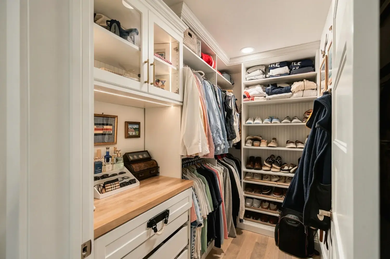 Walk-in closet with hanging rails, shelving, and drawers